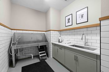 A bathroom with a sink, toilet, and a shower stall.